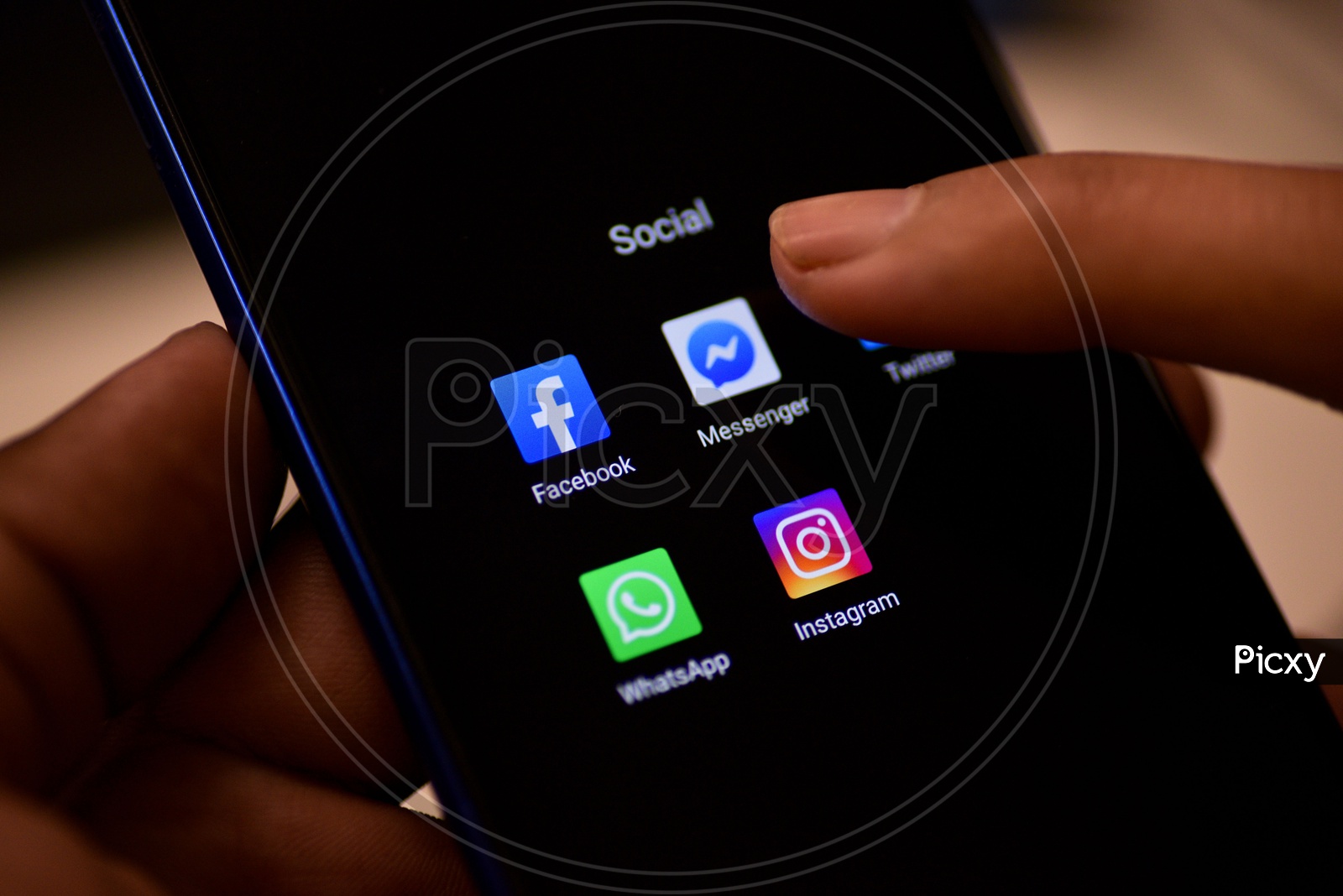 Social Networking Apps Installed Icons On a Smartphone Screen Closeup With Man Finger Opening Facebook Messenger App