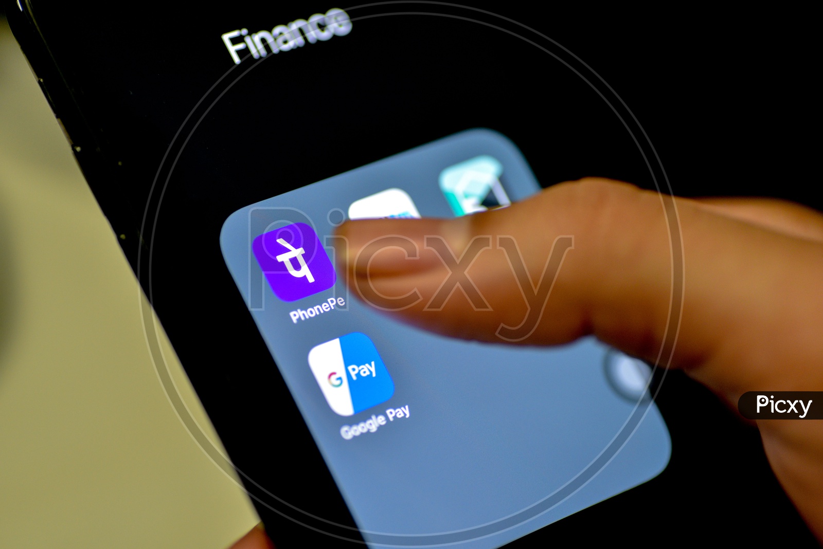 Online Payment, UPI or Bhim Payment and Transaction Apps Installed Icons On a Smartphone Screen Closeup With Man Finger Opening PhonePe App