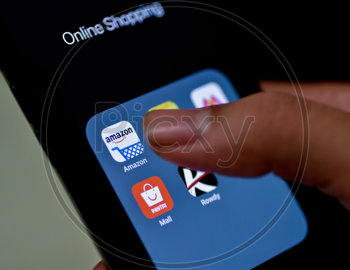 Man Finger Opening Amazon  Online Shopping App On Smartphone With Selective Focus