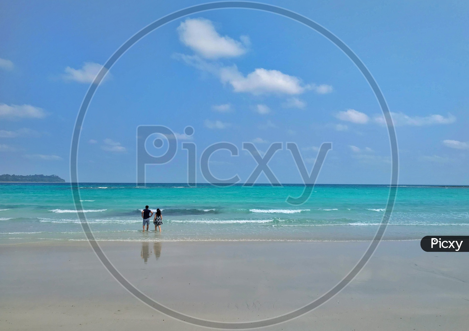 A Couple In a Beach With Blue Sky In  Background