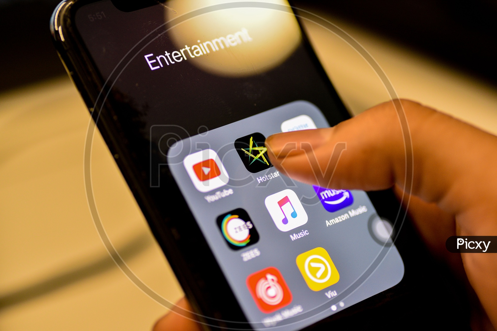 Entertainment Online Streaming Apps Installed Icons  On a Smartphone Screen Closeup With Man Finger Opening Hotstar  App