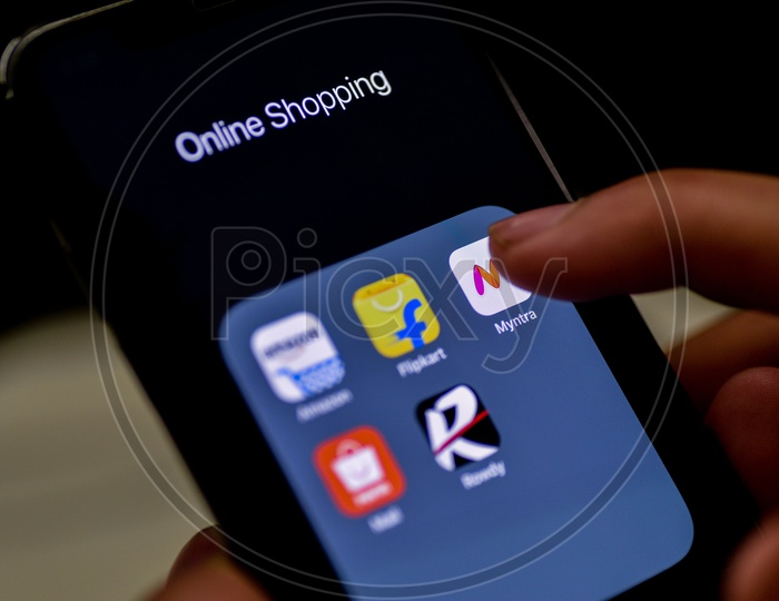 Man Finger Opening Myntra  Online Shopping App On Smartphone With Selective Focus