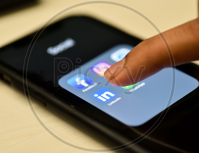 Social Network Apps On a Smartphone Screen Closeup With Man Finger On Linkedin  Icon