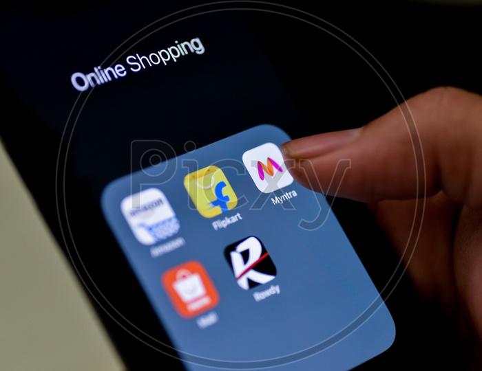 Man Finger Opening Myntra  Online Shopping App On Smartphone With Selective Focus