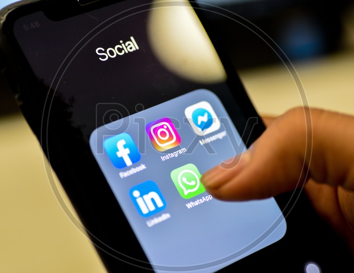 Social Network Apps On a Smartphone Screen Closeup With Man Finger On Whatsapp  Icon