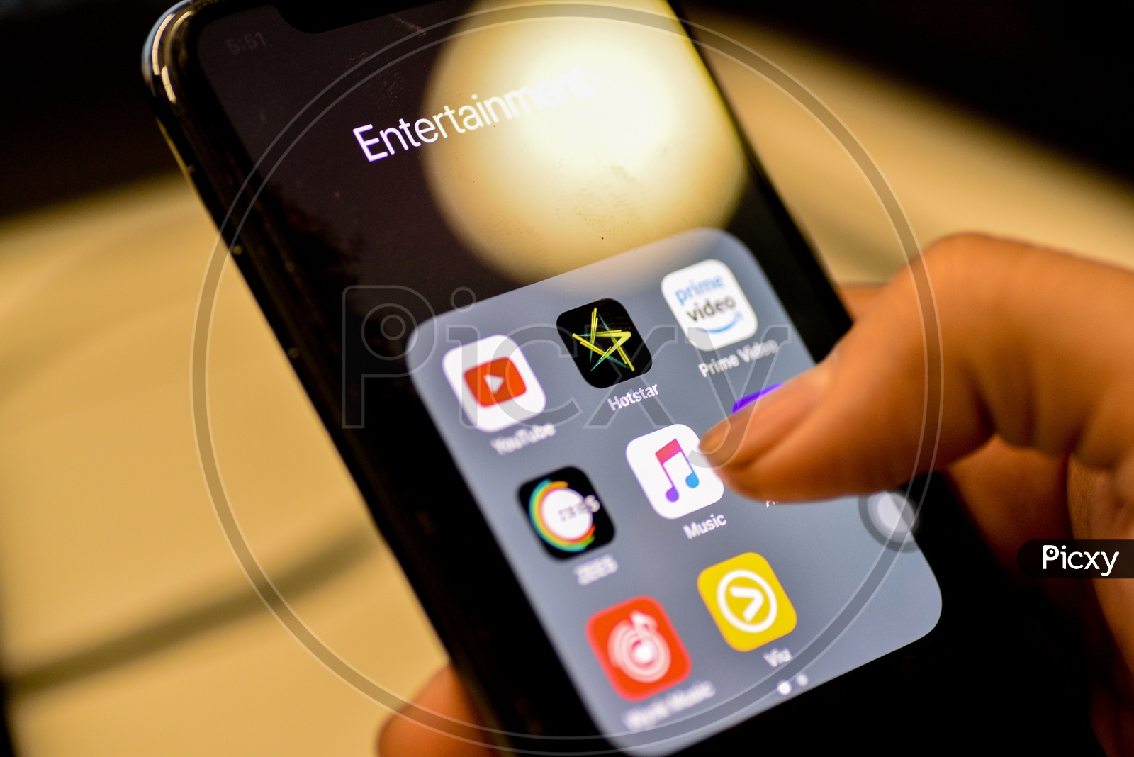 Entertainment Online Music  Streaming Apps Installed Icons  On a Smartphone Screen Closeup With Man Finger Opening   Music App