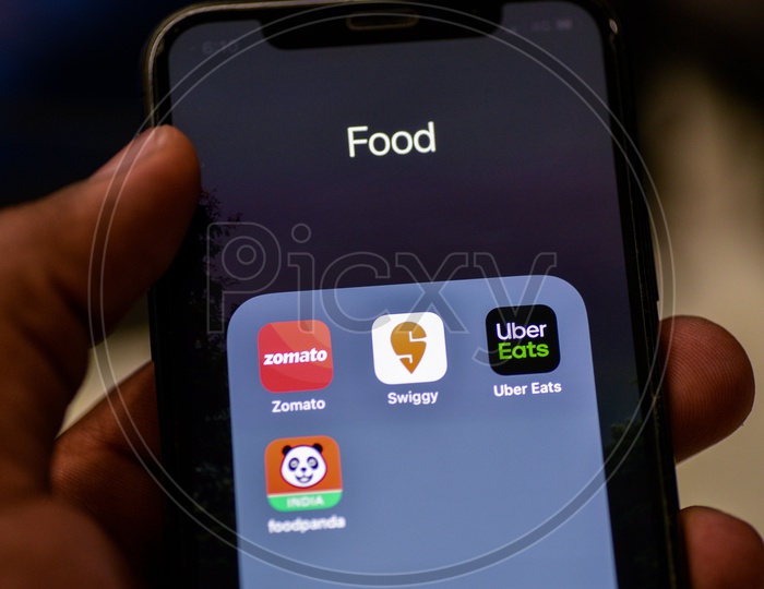 Online Food Ordering Or Delivering Apps Or Applications Icons On a Smartphone Screen With Selective Focus