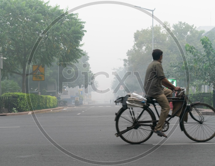 A man riding bicycle during Hazy morning due to Pollution(smog) at severe level in Delhi NCR after Diwali