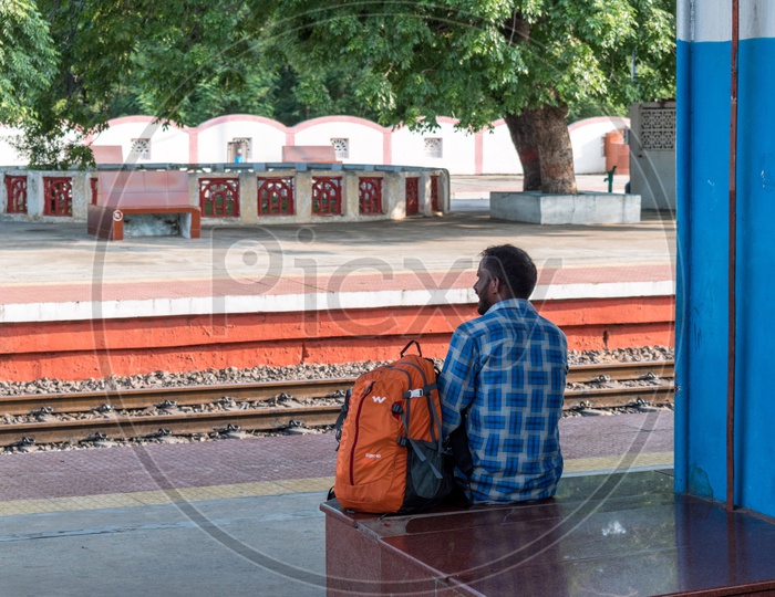 Man sitting at railway station
