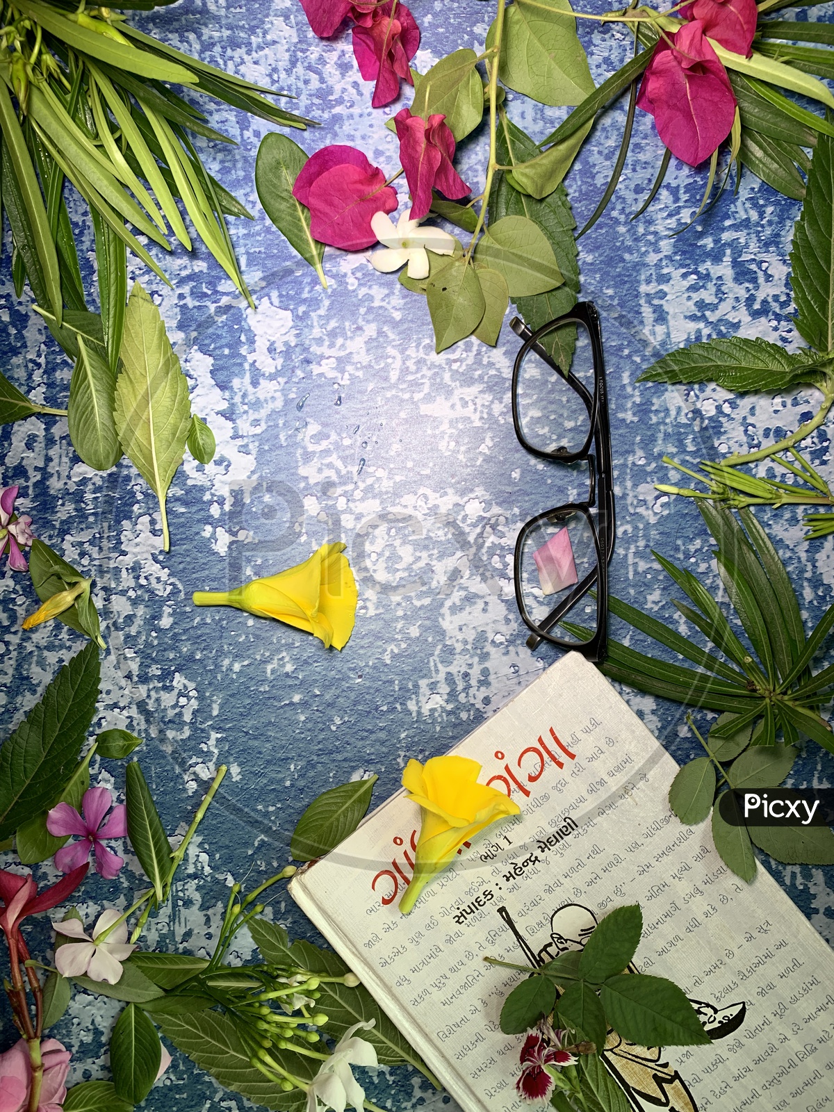 flat lay flowers,a book and a glasses