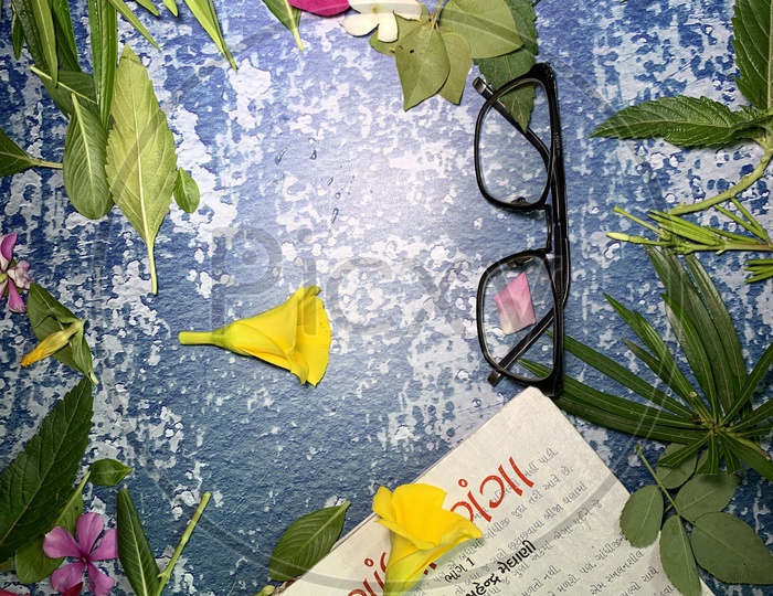 flat lay flowers,a book and a glasses