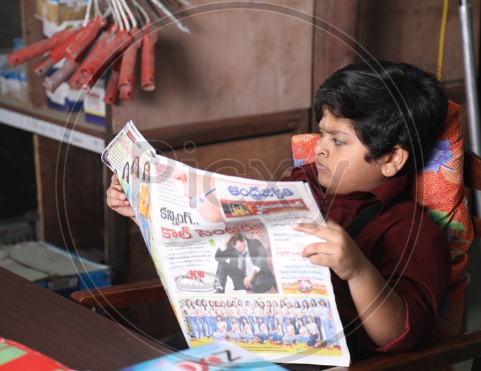 Young Boy reading Newspaper