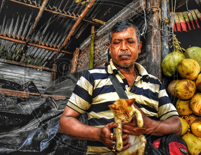 Man holding cat in coconut shop