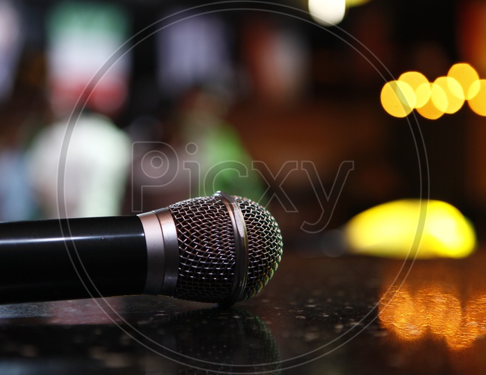 A Mic With Neon Lights Bokeh With in a Pub