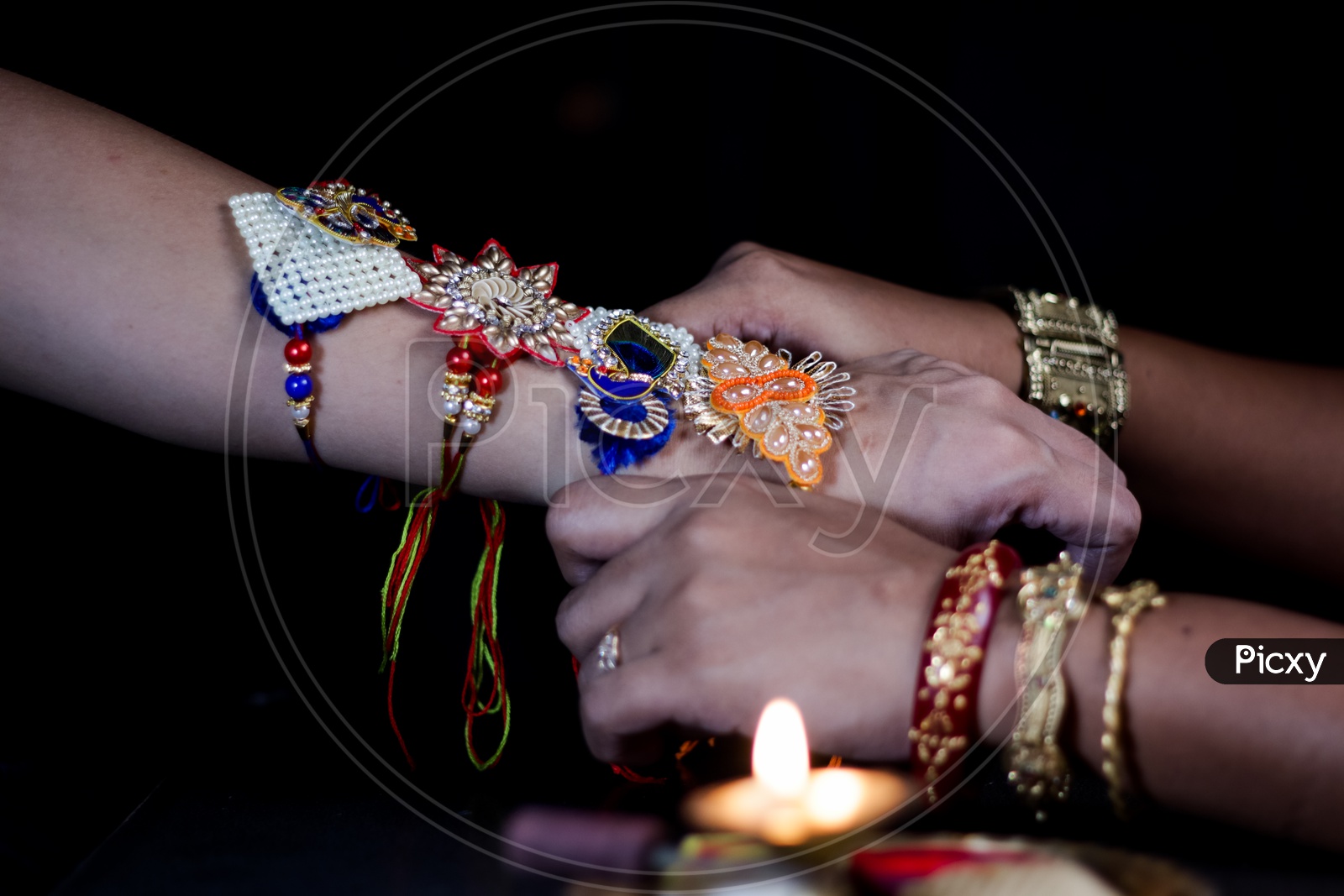 Sister Tying Rakhi To a brother Hand  During Traditional  Hindu Festival Raksha Bandhan  Over a Dark Black Background