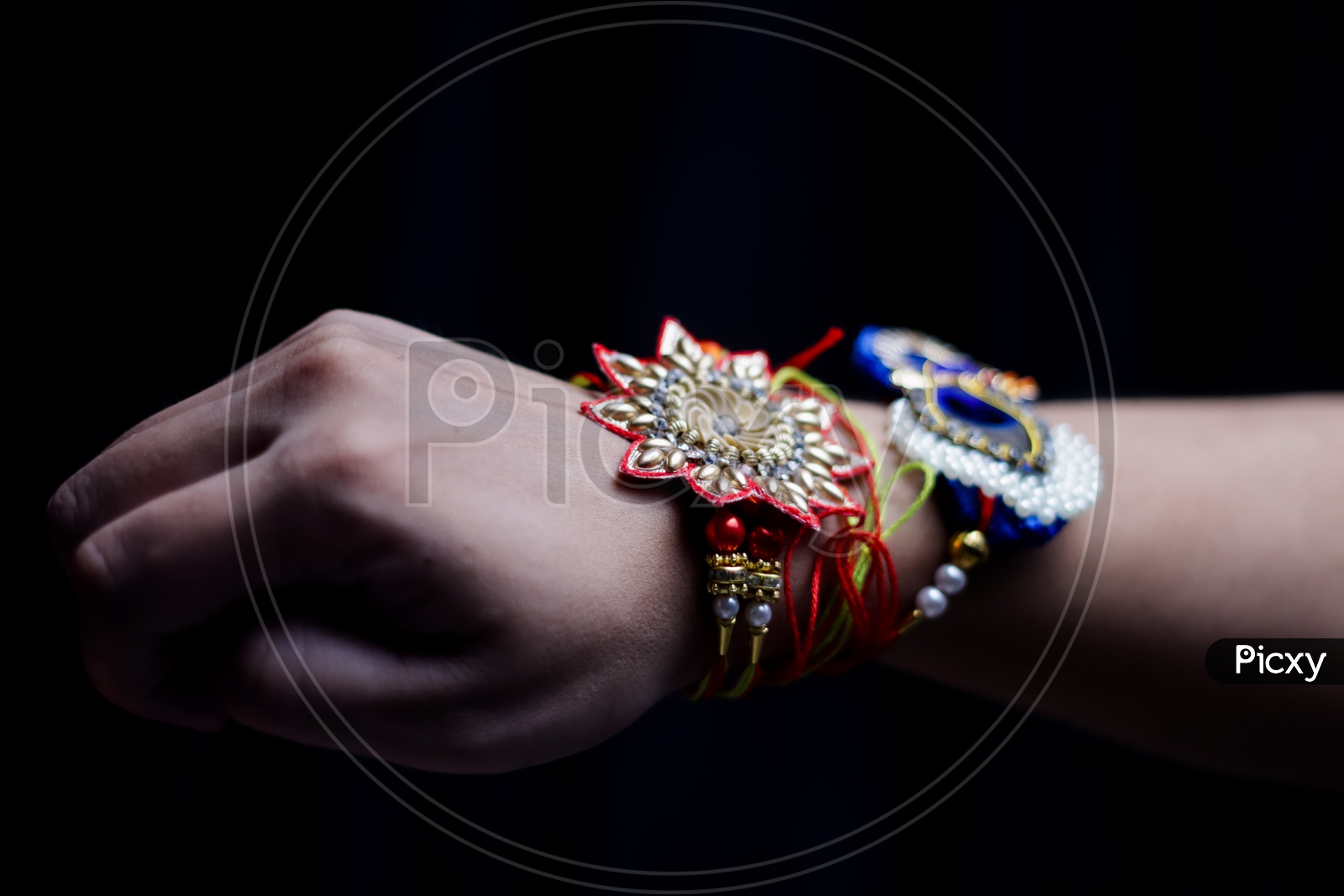 Elegant Rakhi Tied Hand Of a Guy  During Traditional Hindu Festival Raksha bandhan With Dark Black Background