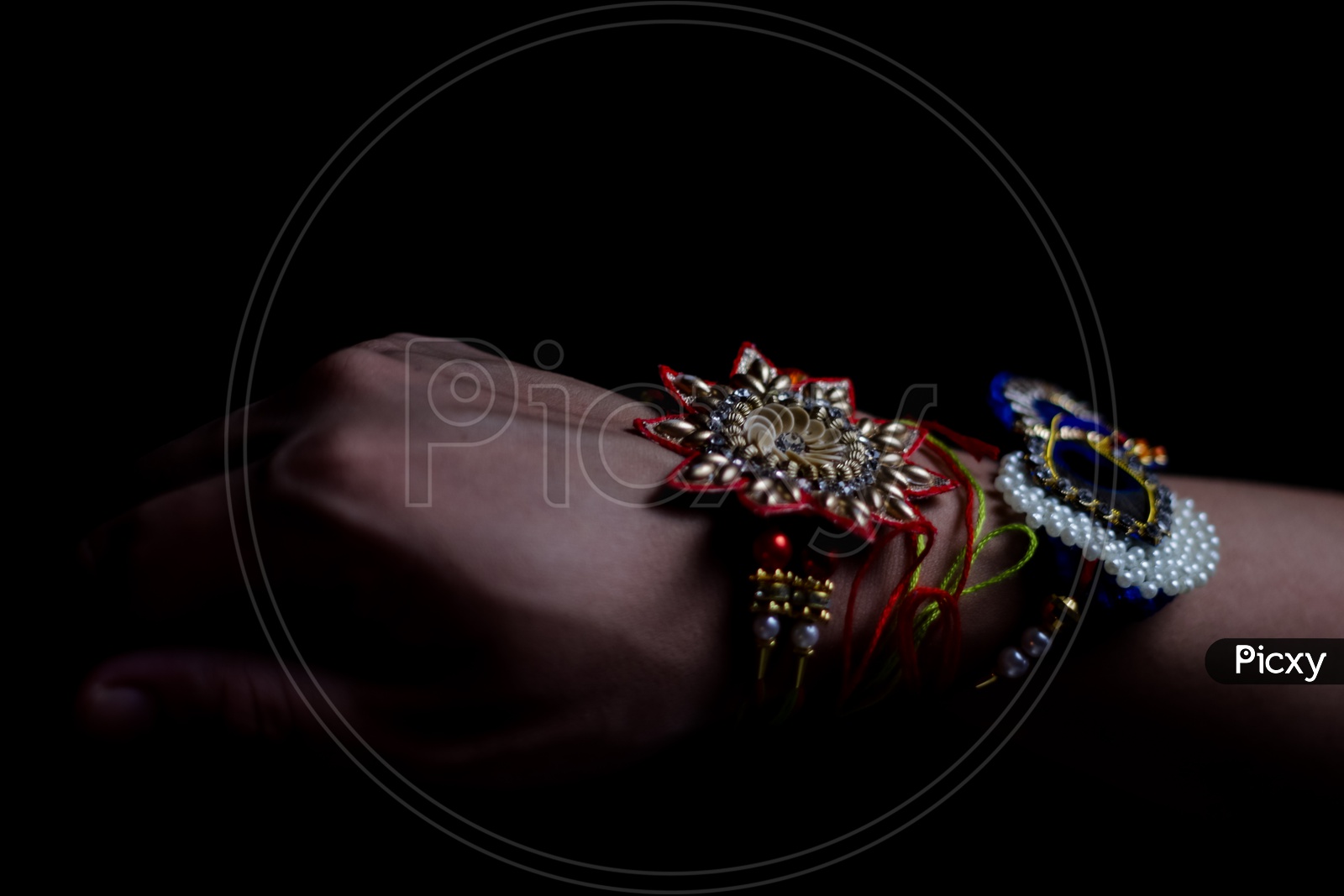 Elegant Rakhi Tied Hand Of a Guy  During Traditional Hindu Festival Raksha bandhan With Dark Black Background