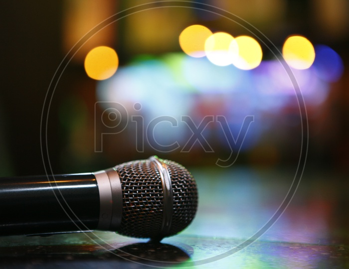 A Mic With Neon Lights Bokeh With in a Pub