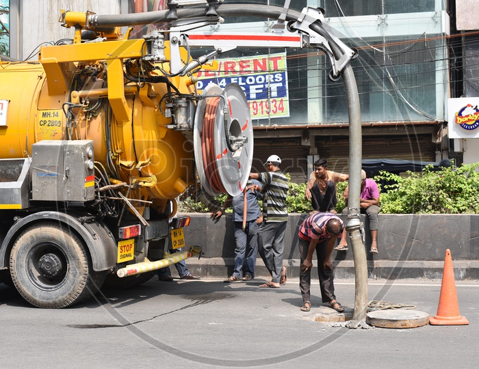 Septic Tank Suction Vehicle Cleaning Sewage From Pot Holes On The Roads of Hyderabad