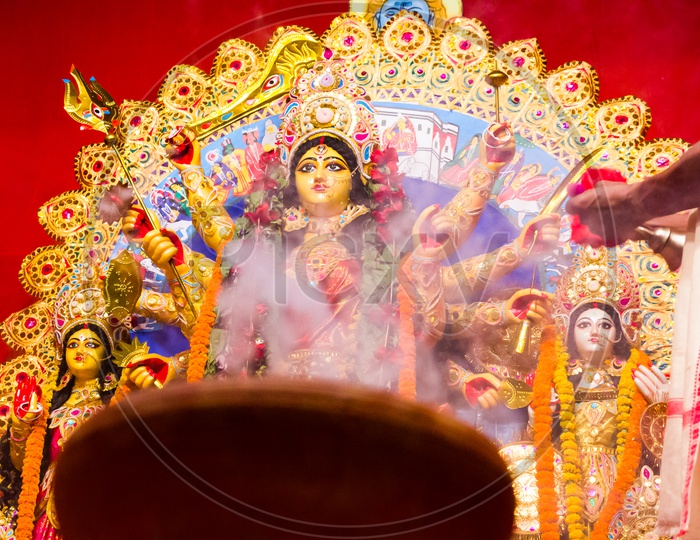 Hazed Picture Of Goddess Durga In Background Of Smoke Of Worship