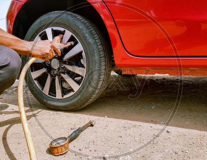 Filling Of Air In A Rear Tyre Of A Motor Car To Maintain Air Pressure