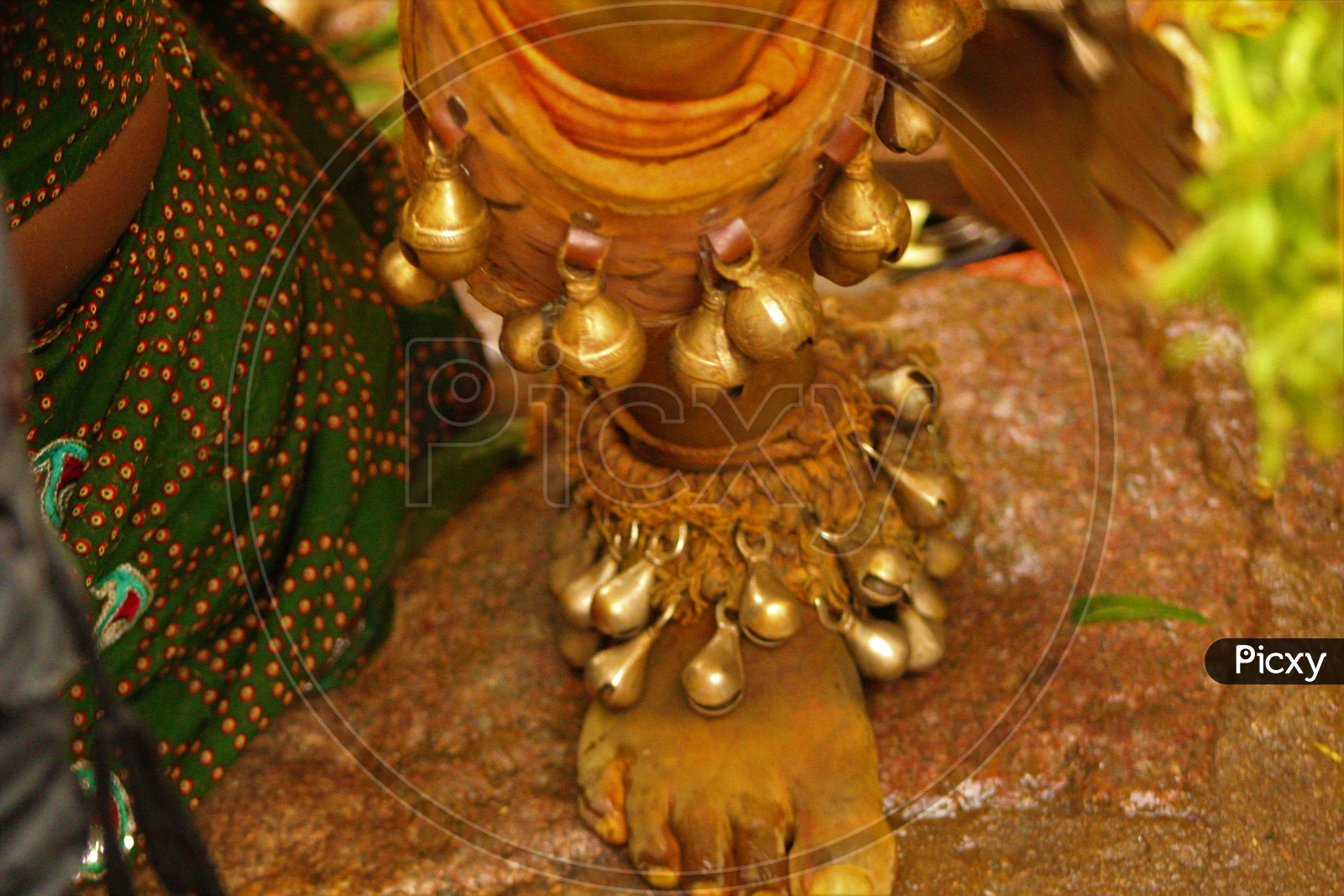 Feet Of Pothu Raju With Brass Shells During Bonalu Festival Celebrations