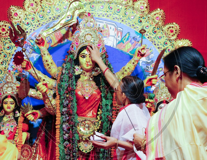 October, 2018, Kolkata, India. Bengali Women Greeting Idol Of Godess Durga With Sweets And Betel Leaves In A Very Important Ritual