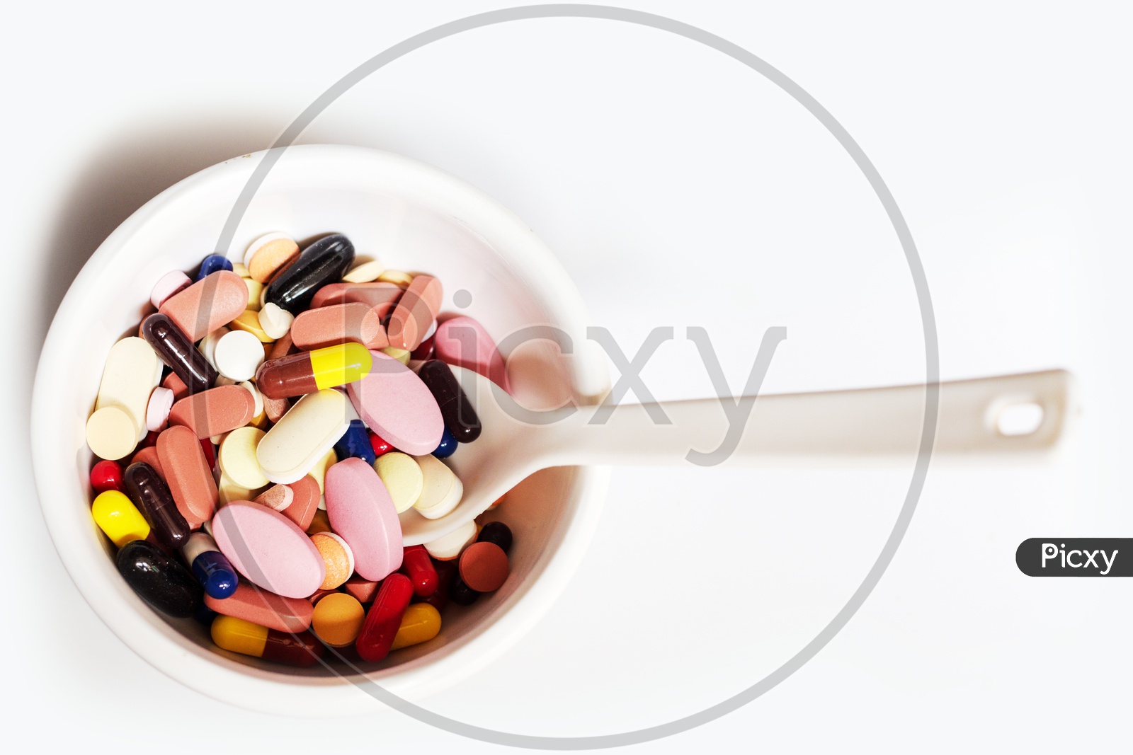 Bowl Of Medicine Pills Tablets Capsules In White Background