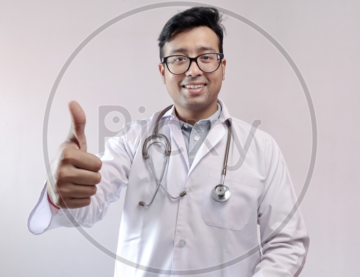 Male Indian Doctor In White Coat And Stethoscope Showing Thumbs Up In Confidence