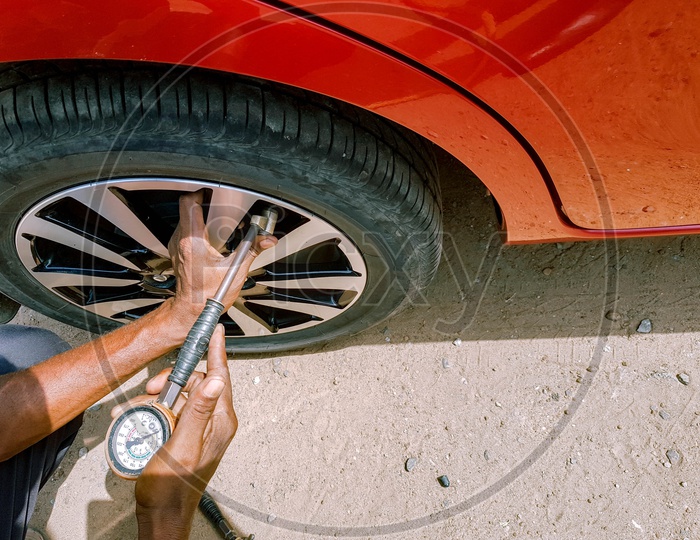 Checking Of Air Pressure With A Manometer In A Rear Tyre Of A Motor Car By Hand Of Mechanic