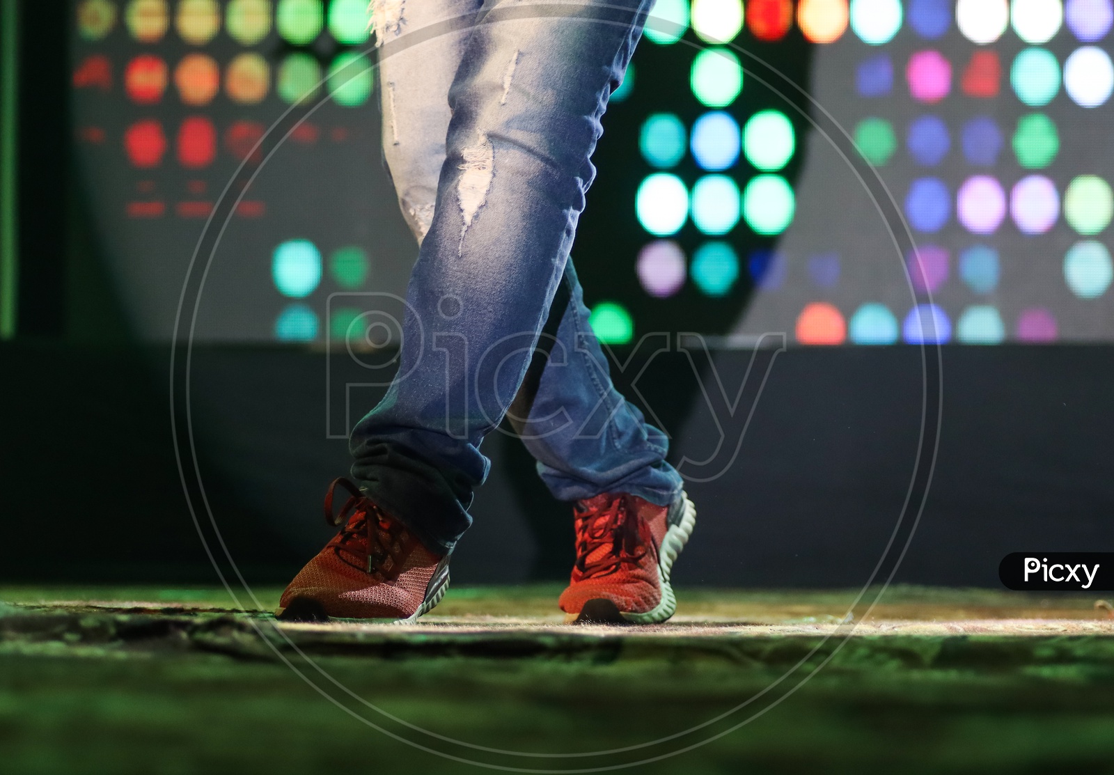 Feet Of A Dancer On Stage Doing Hip Hop Dancing Stance With Background Neon Lights