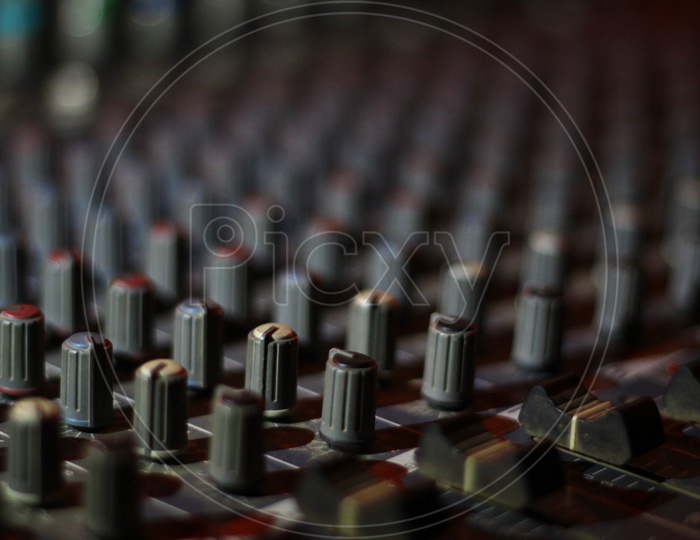 Close Up View Of Knobs And Sliders Of Light And Sound Board Console At A Concert Theater