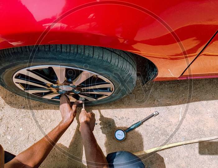 Filling Of Air In A Rear Tyre Of A Motor Car To Maintain Air Pressure
