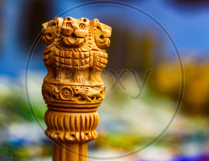 Miniature Wooden Replica Of Ashoka Stambha. An Ancient Historic Indian Monument.Lion Face Pliiar Of Ashoka, Indian National Emblem.