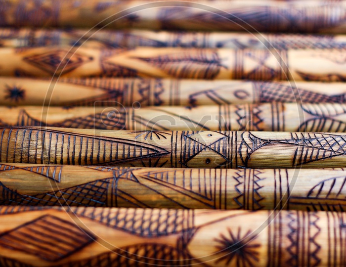 Hand Made Wooden Bamboo Carving Engraved Fish Figure Artwork On Bamboo, Rows Of Engraved Bamboo Sticks. Textured Background. Tribal Artwork.