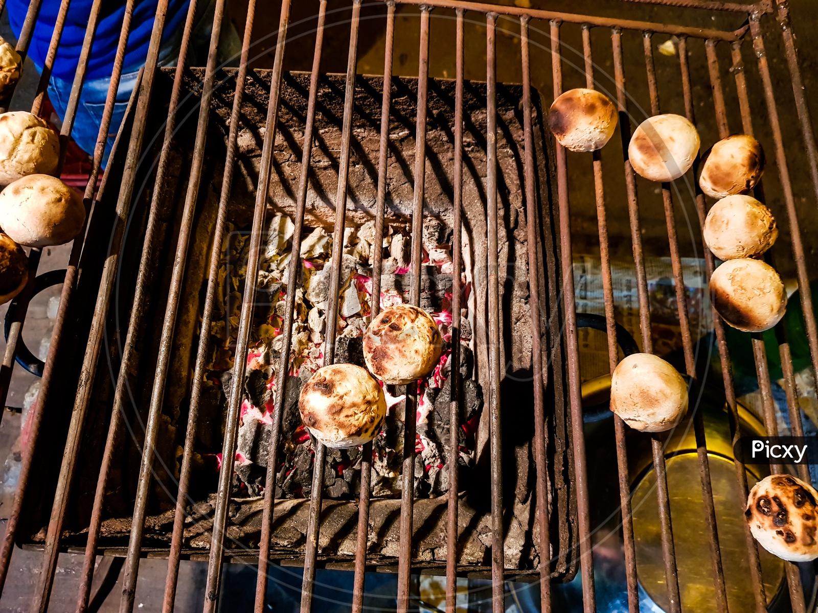 Litti, A Common North Indian Food Is Being Baked Road Side On A Coal Grill
