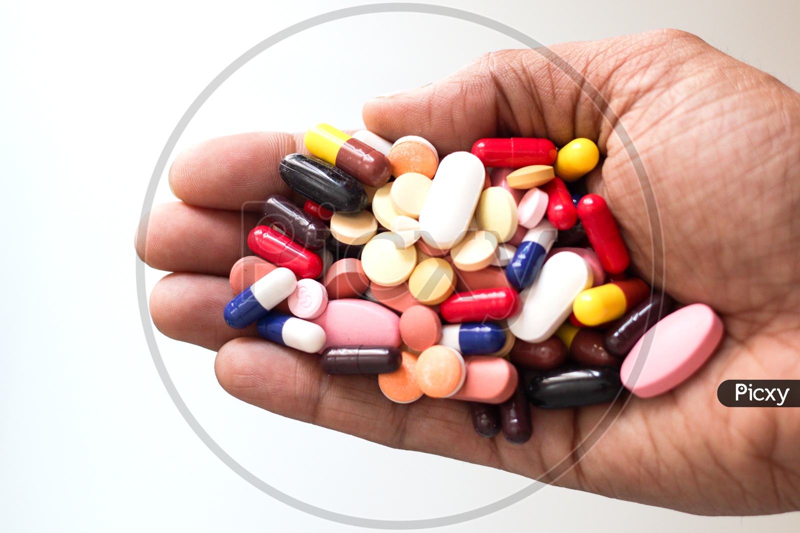 Pile Of Medicine Pills Tablets Capsules In A Palm In White Background