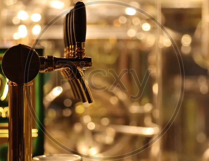 Closeup Of Taps Row At a Bar Counter At a Brewery