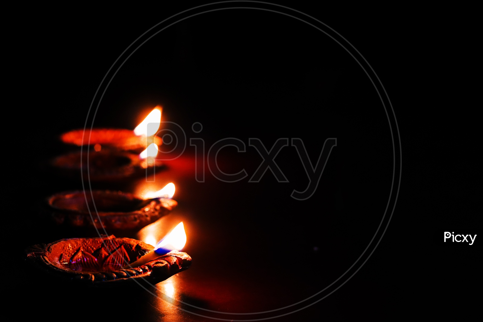 Diwali Dias  Lighted  Over a Black Background  And Space For Text