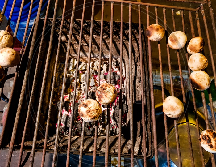 Litti, A Common North Indian Food Is Being Baked Road Side On A Coal Grill