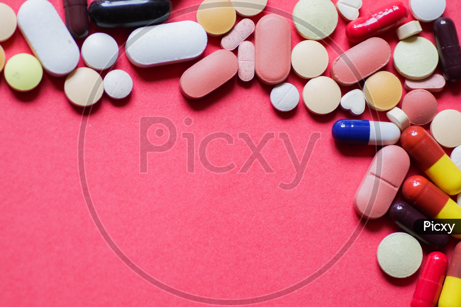 Image of Heap Of Tablets And Capsules In Pink Background With Space For