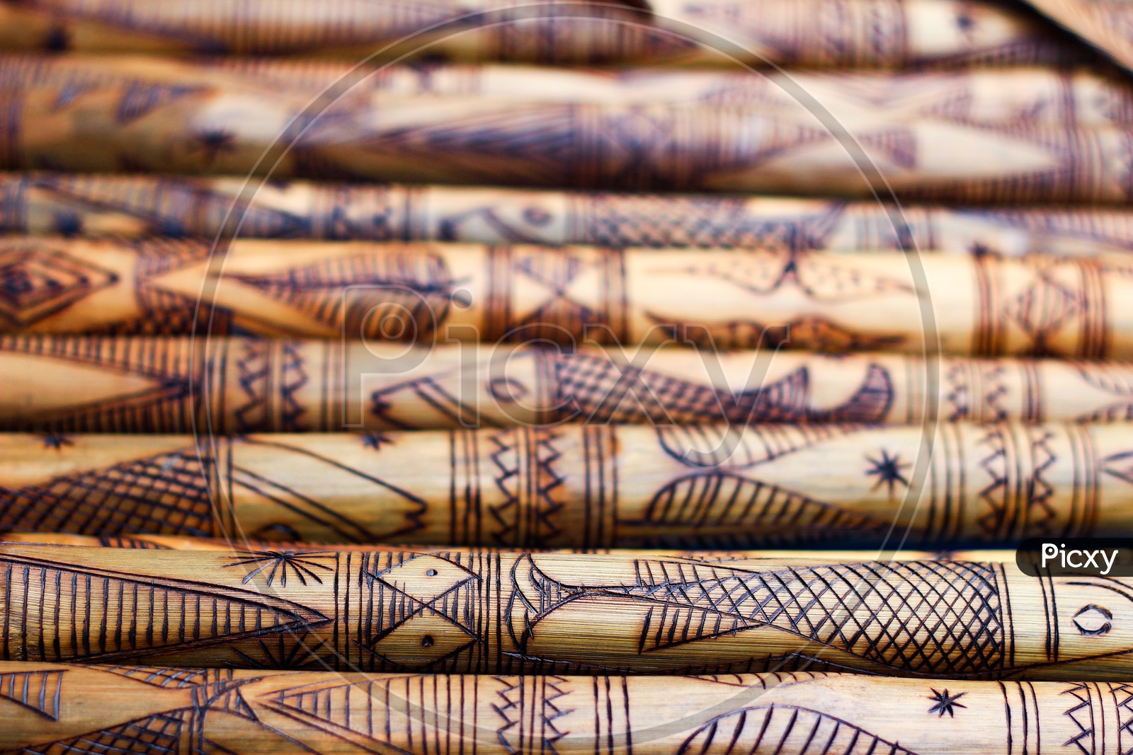 Hand Made Wooden Bamboo Carving Engraved Fish Figure Artwork On Bamboo, Rows Of Engraved Bamboo Sticks. Textured Background. Tribal Artwork.