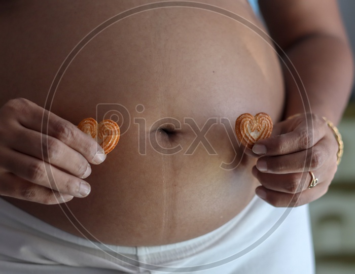 Belly Of A Pregnant Woman With Focus On Abdomen
