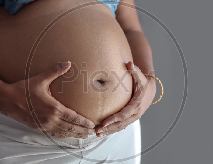 Belly Of A Pregnant Woman With Focus On Abdomen