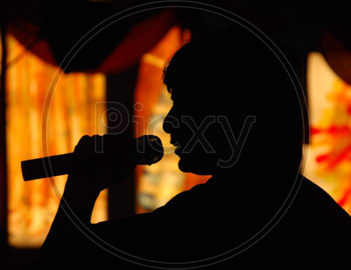 Silhouette Of a Man With a Mic In Hand