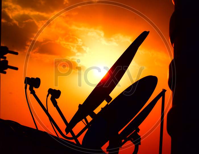 Silhouette Of DTH Antenna over Golden Sunset Sky