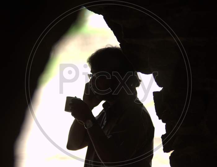 Silhouette Of Man Having a Cup of Coffee