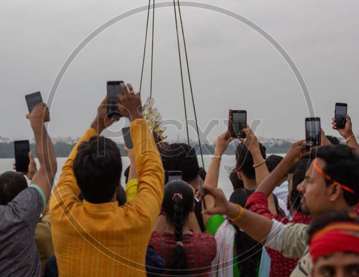 People Capturing the Ganesh Vinayaka Idol Nimarjanam Immersion in Mobiles At Tank Bund Hyderabad, 12th September 2019