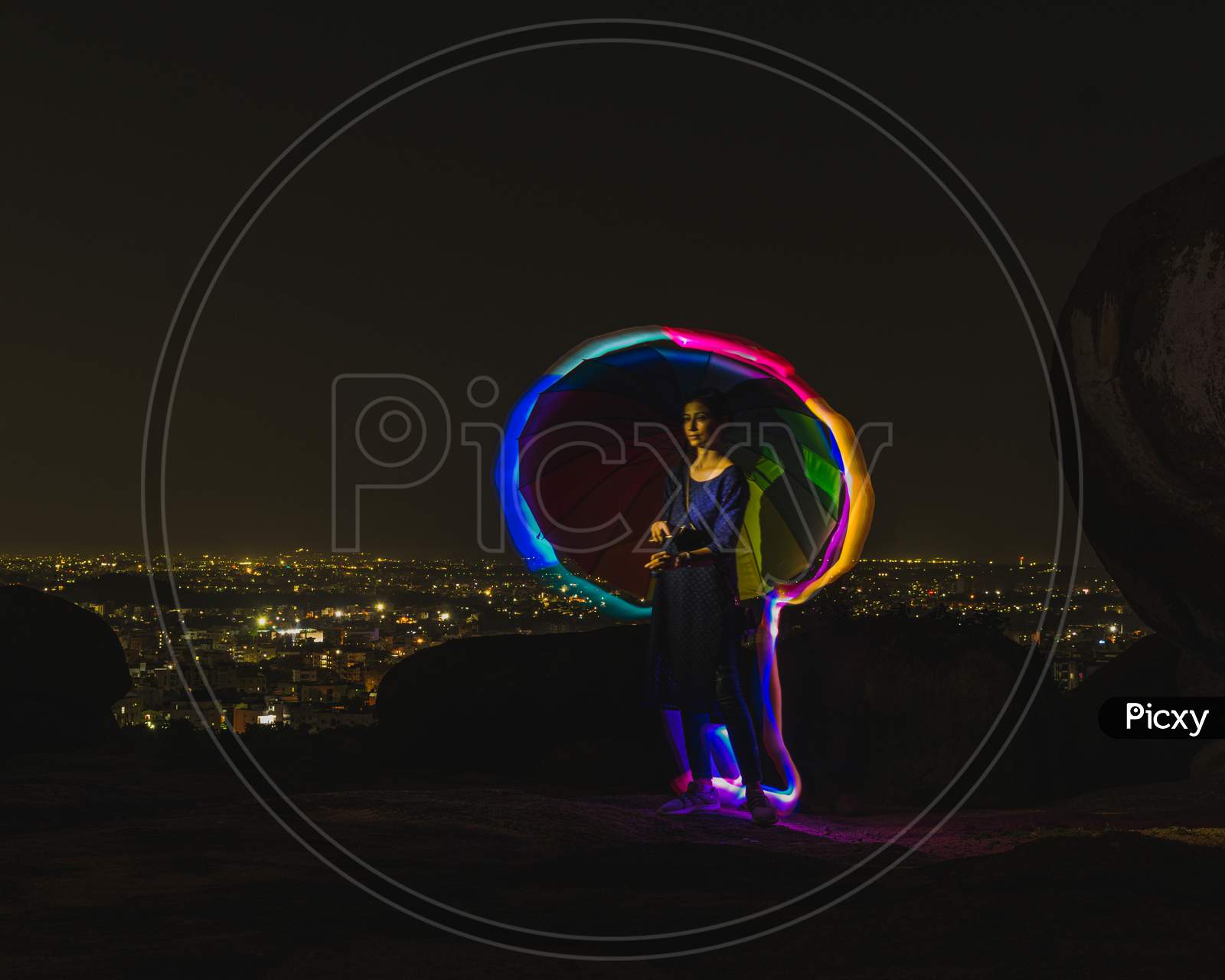 Woman With An Umbrella And Rainbow Neon Lights