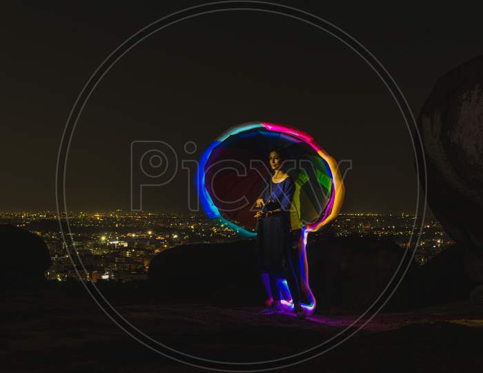 Woman With An Umbrella And Rainbow Neon Lights